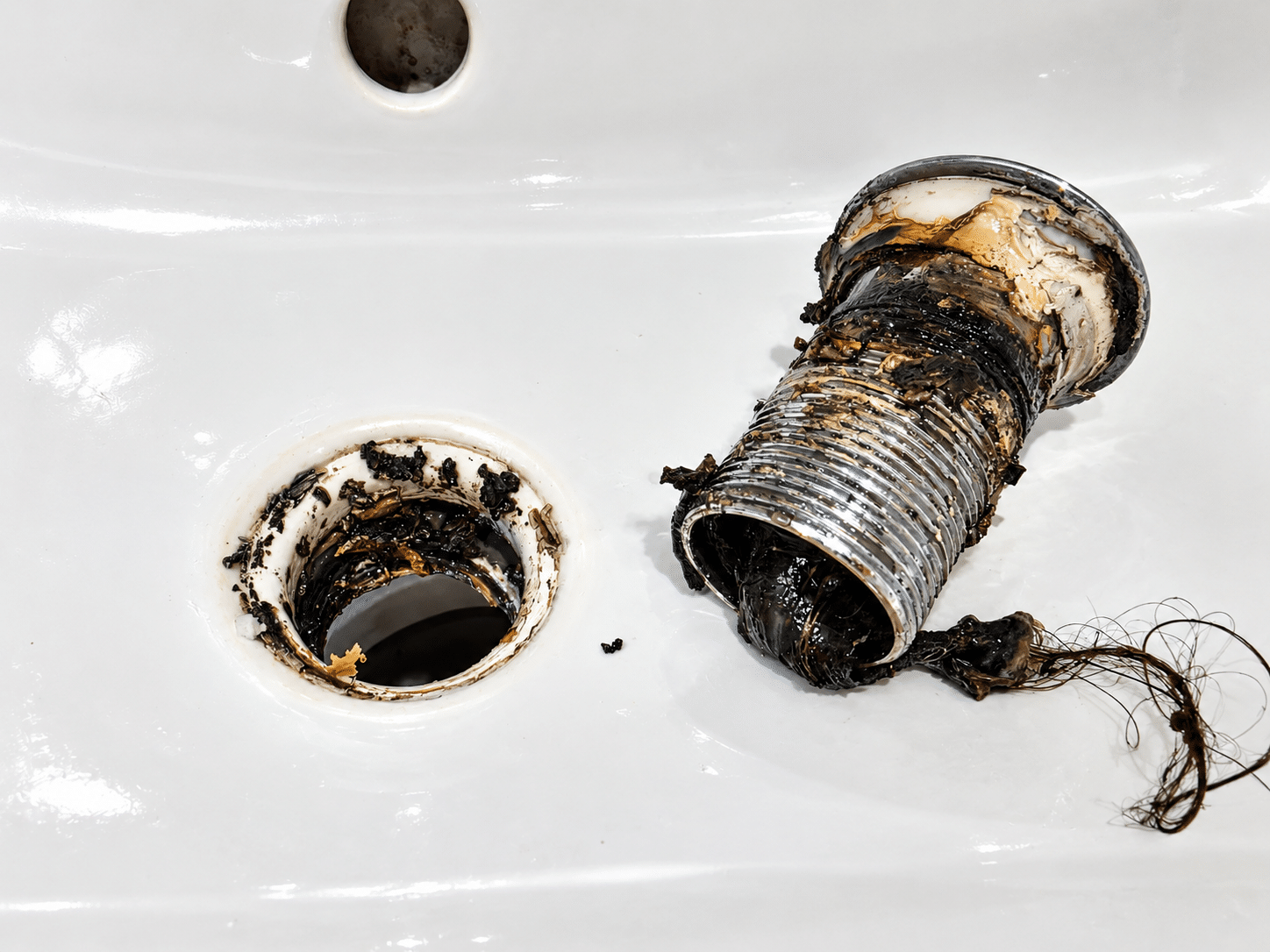 Emergency plumber in Harold’s Cross fixing a leaking pipe under a sink